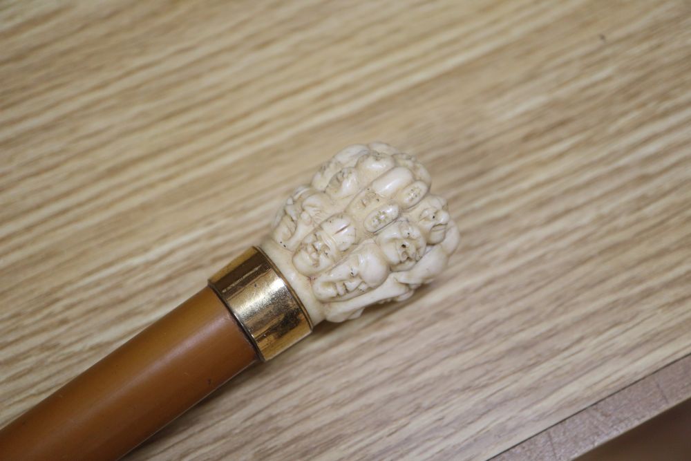 An umbrella with a carved Chinese ivory handle, c.1900, length 73cm